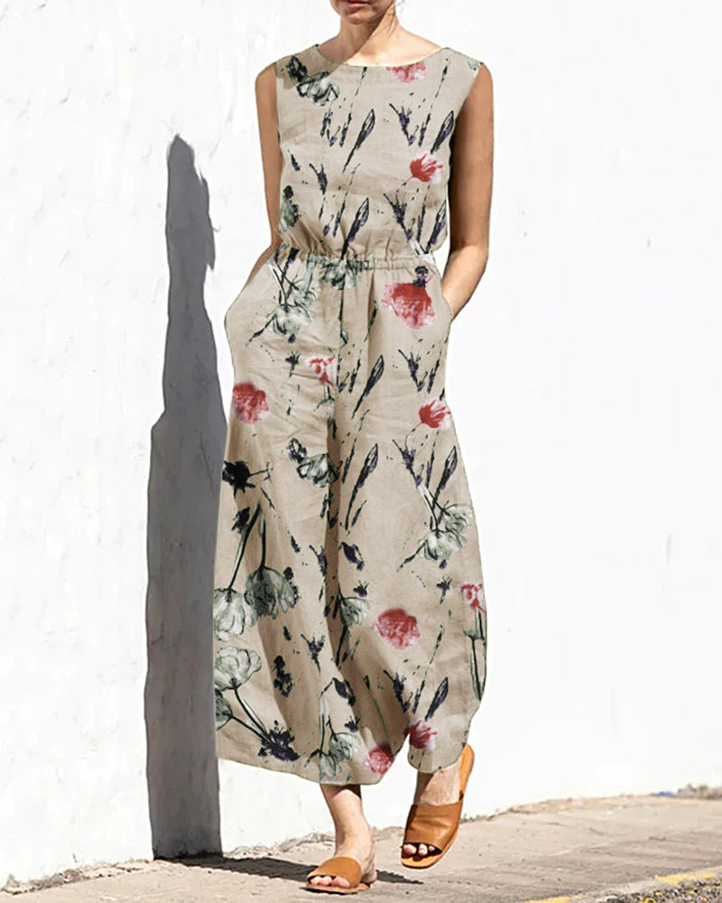 Cream printed sleeveless jumpsuit with elastic waist and floral leaf pattern
