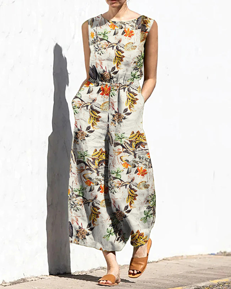 Light cream printed sleeveless jumpsuit with elastic waist and botanical bird pattern