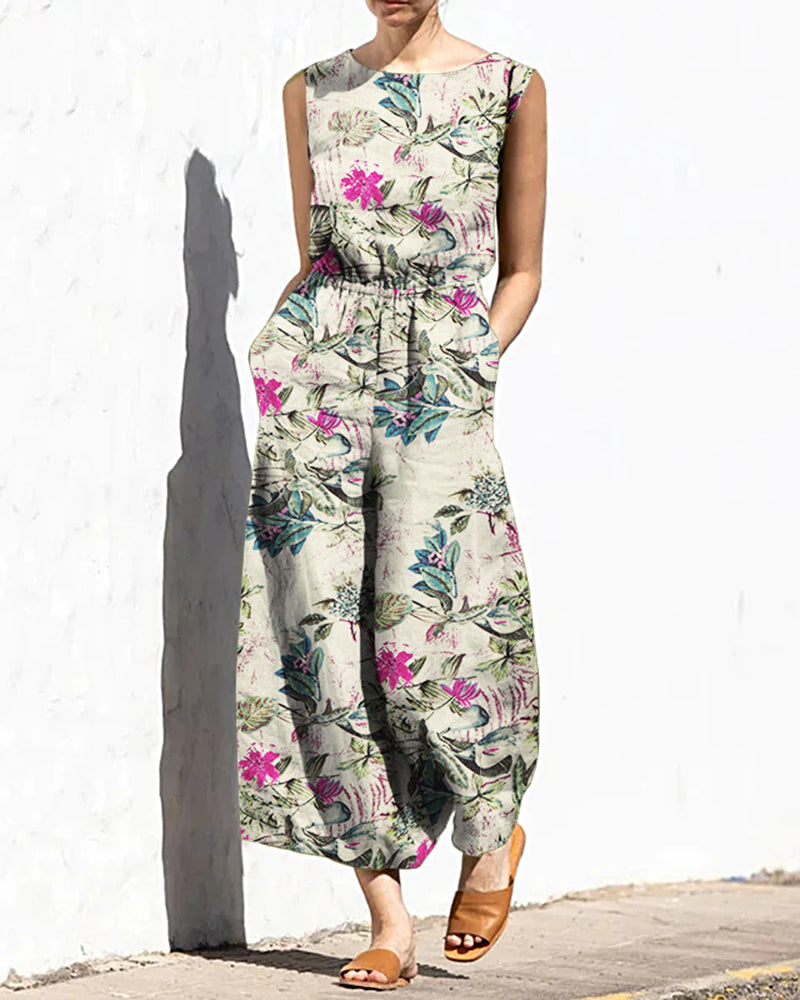Off-white printed sleeveless jumpsuit with elastic waist and colorful floral pattern
