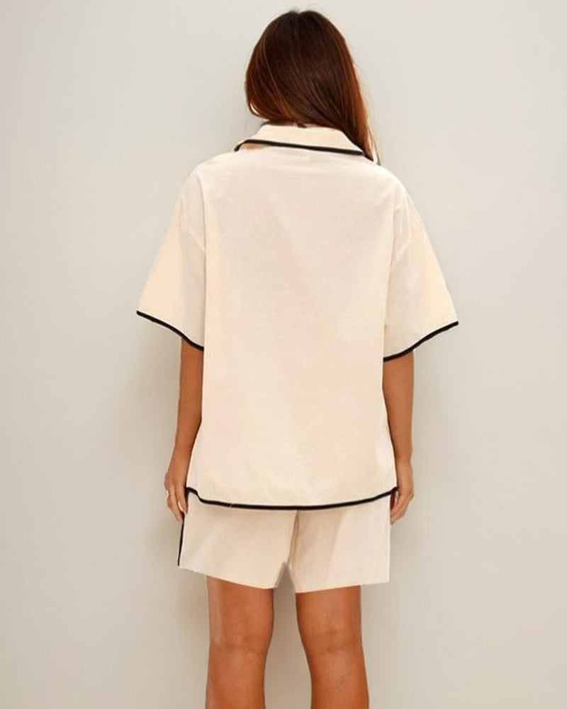 Beige linen pajama set showing back of lace-up shirt and shorts.