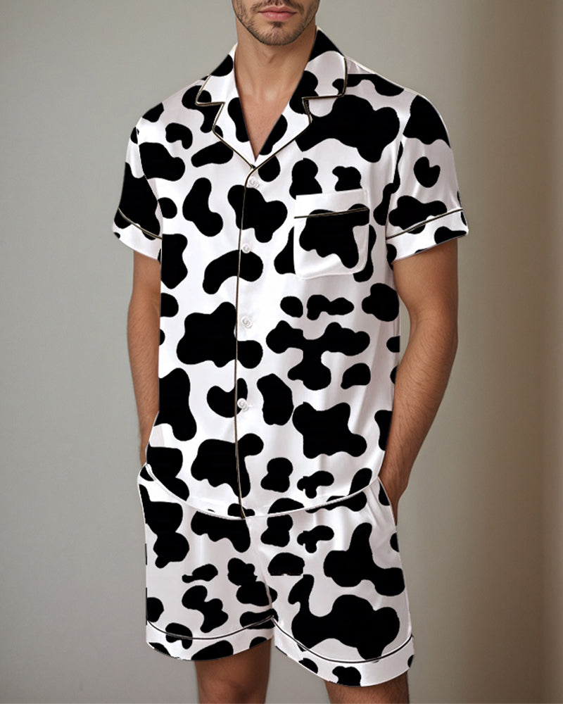Satin pajama set with black-and-white cow print short-sleeve shirt and shorts