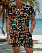 Men’s satin pajama top and shorts with colorful retro city-word graffiti pattern on dark fabric