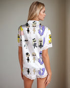 Women’s satin pajama set with illustrated girl print back top and lace-trim shorts