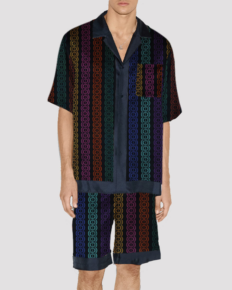 Men's satin pajama set with vertical striped circle pattern, button-up shirt and shorts