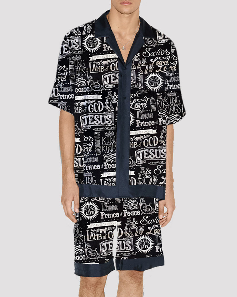 Men's satin pajama set with black-and-white religious typography print, button-up and shorts