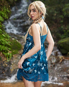 Blue satin lingerie slip dress in side view with butterfly print and lace-trim hem, thin straps