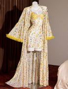 Floral kimono robe on mannequin with yellow feather-trim hem and open-front sleeves