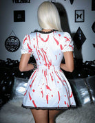 White and red splatter mini dress from back with gathered waist and puff sleeves
