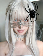 Black spider headpiece hair clips with lace bow detail on light hair, front view