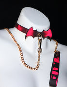 Red bat-wing color-changing choker with chain leash set on mannequin