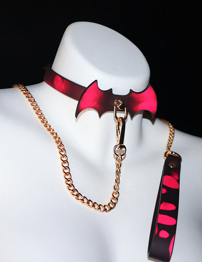 Red bat-wing color-changing choker with chain leash set on mannequin