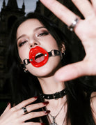 Black adjustable ring gag choker with red mouth ring and metal studs