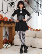 Black gothic mini dress with corset bodice, long sleeves, and striped tights