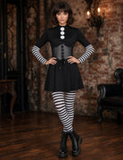 Black gothic mini dress with buttoned corset bodice, striped tights, and lace-up boots