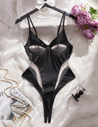 Black PU leather bodysuit on hanger with underbust cut-outs and open crotch.