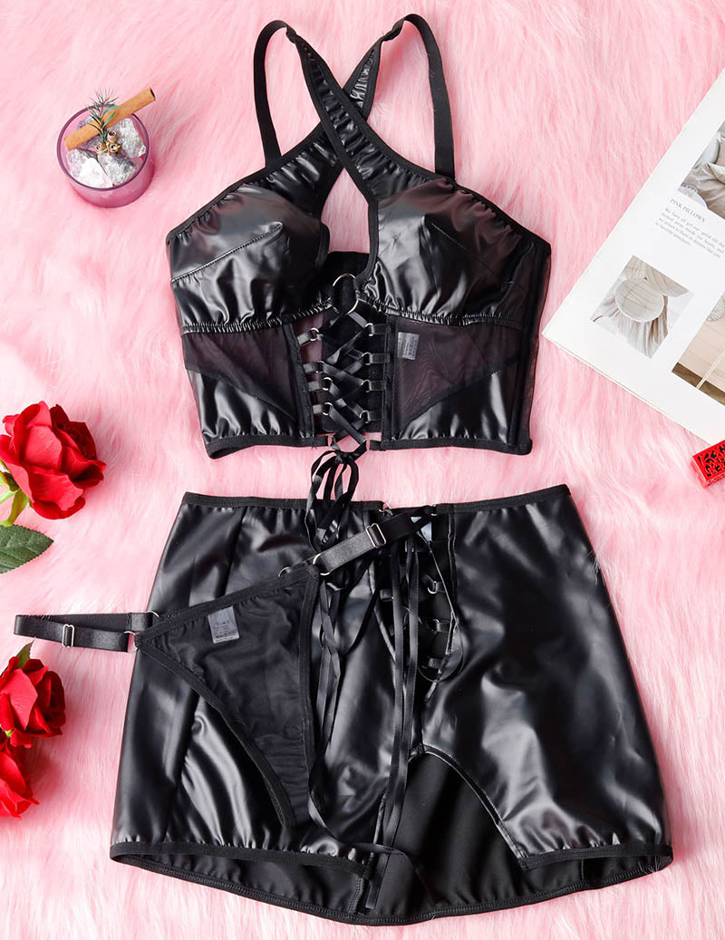 Black PU lingerie set flat lay: halter top with lace-up front and mini skirt
