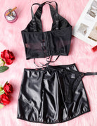 Black lingerie set flat lay: halter bra with adjustable straps and mini skirt