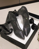 Rhinestone fishnet over-the-knee stiletto boots, crisscross sparkly texture, side angle