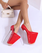 Red patent platform stiletto pump with pointed toe and slender tall stiletto heel