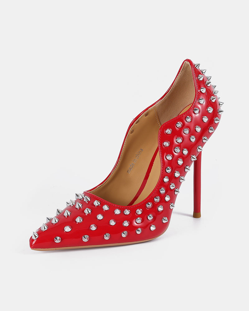 Red patent pointed-toe stiletto pump with silver spike studs and high heel