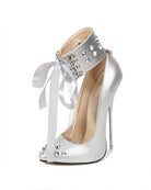 Silver spike-studded pointed-toe stiletto pump with ankle strap and white ribbon tie