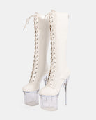 White knee-high patent lace-up stiletto boots with clear platform heel