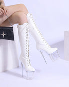 White knee-high lace-up patent stiletto boots with clear platform heel, angled view