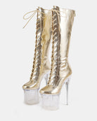 Gold metallic knee-high lace-up stiletto boots with clear platform heels, front view
