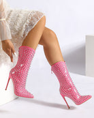 Pink patent leather mid-calf stiletto boots with pointed toe and silver spike studs