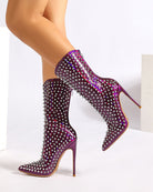 Purple mid-calf stiletto boot with pointed toe and silver spike studs, front angle