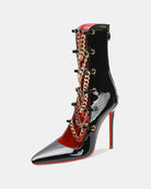 Black patent stiletto ankle boot with gold chain detail and contrast red lining.