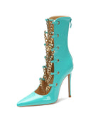 Sky blue patent stiletto ankle boot with gold chain trim and pointed toe.