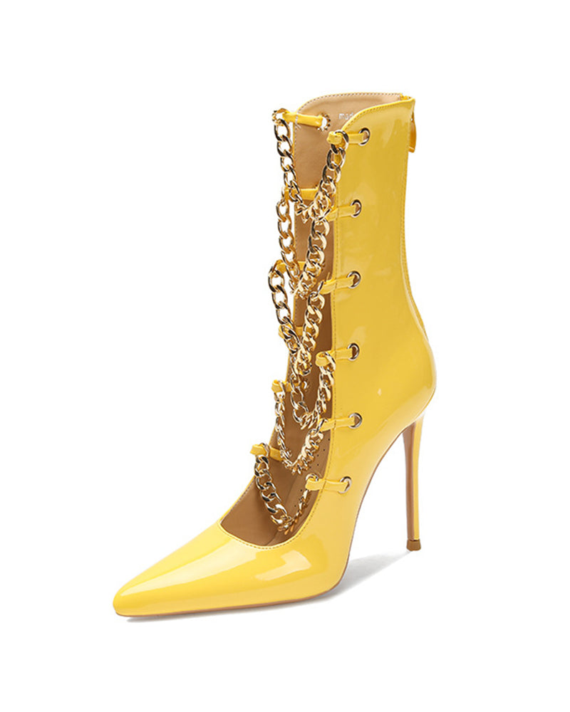 Yellow patent stiletto ankle boot with gold chain detail and slim heel.