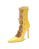 Yellow patent stiletto ankle boot with gold chain detail and slim heel.