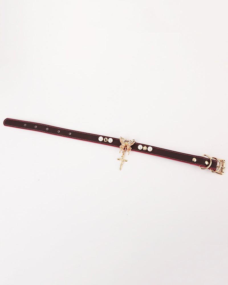 Black leather collar strap with pearl studs, gold buckle, and cross pendant charm