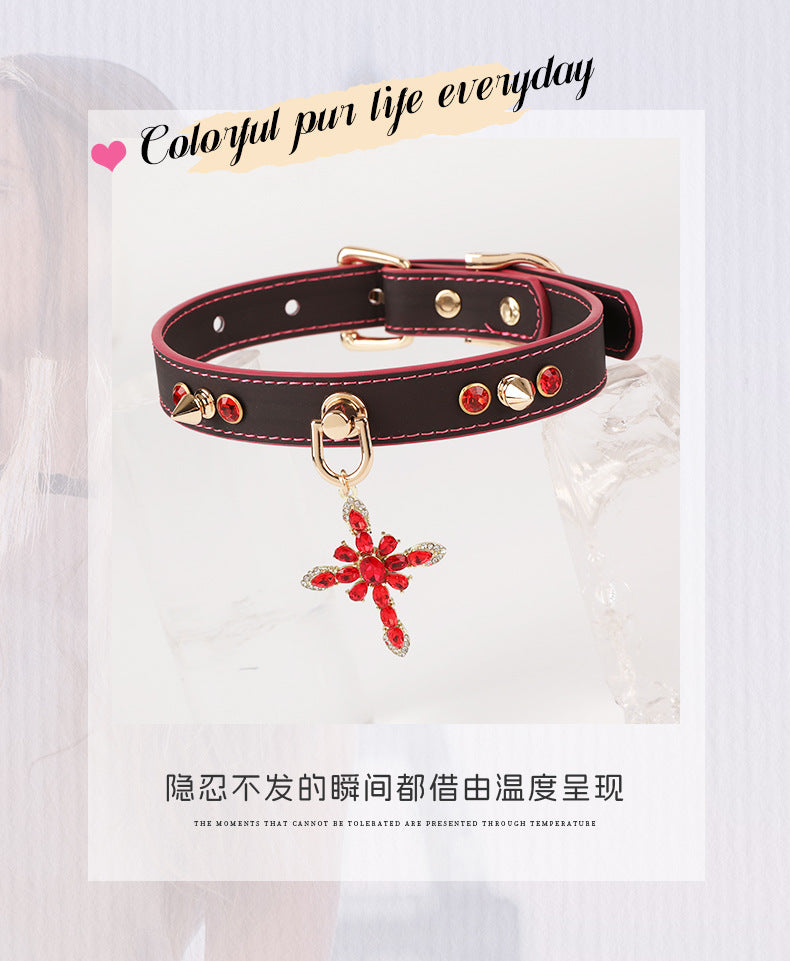Black PU pet collar with magenta stitching, metal ring clasp, and hanging red cross charm