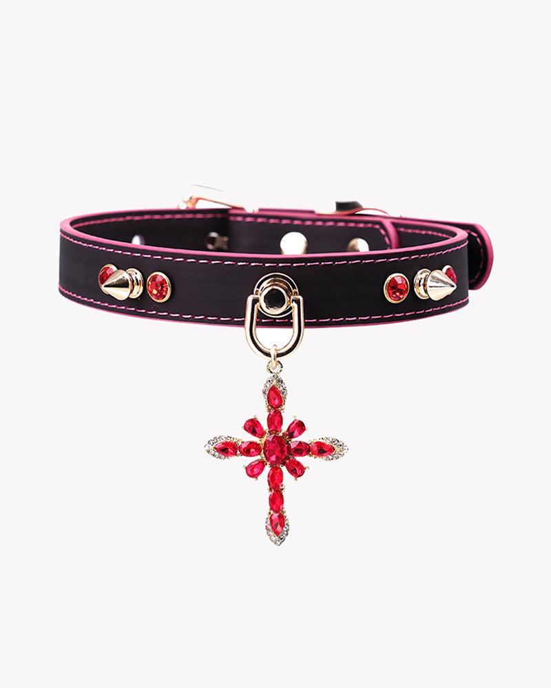 Black PU pet collar with magenta edge stitch, stud accents, and red jeweled cross charm