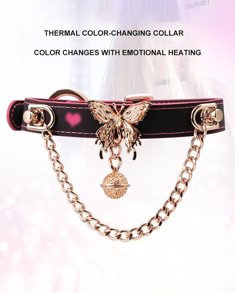 Black leather choker with butterfly and bell charms, red-stitched trim and heart detail