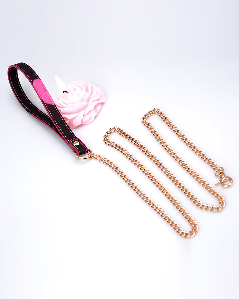 Gold-tone chain dog leash with pink leather handle and clip hardware, with flower accent
