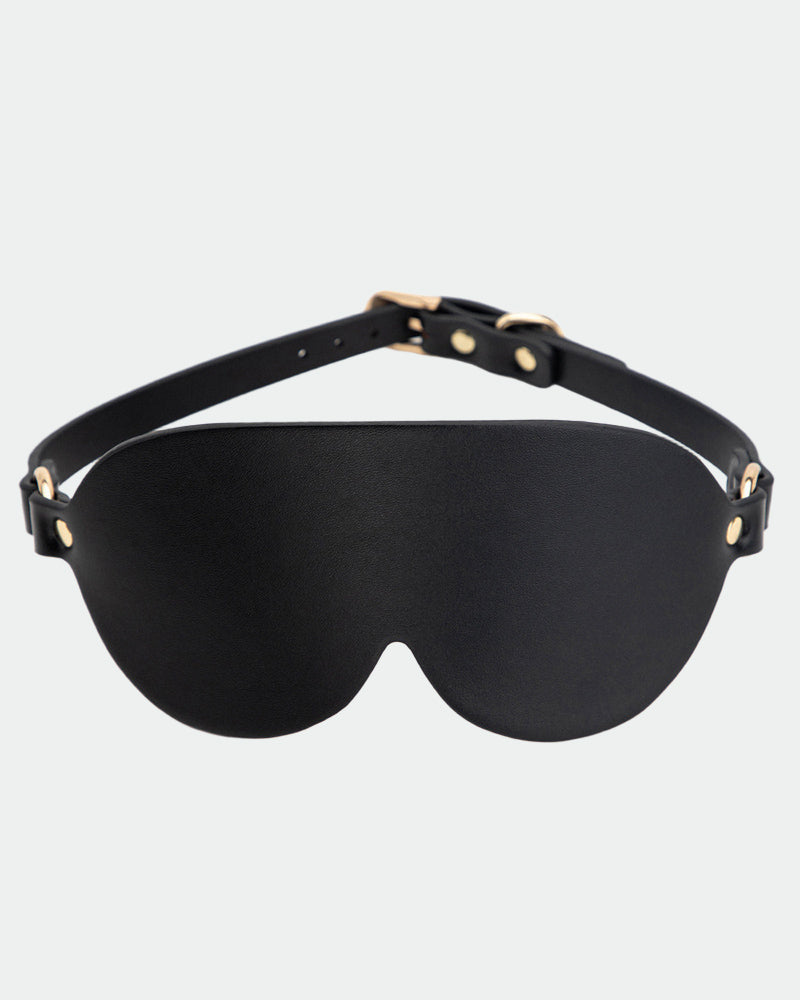 Black leather eye mask with curved eye cups and adjustable strap, metal rivets