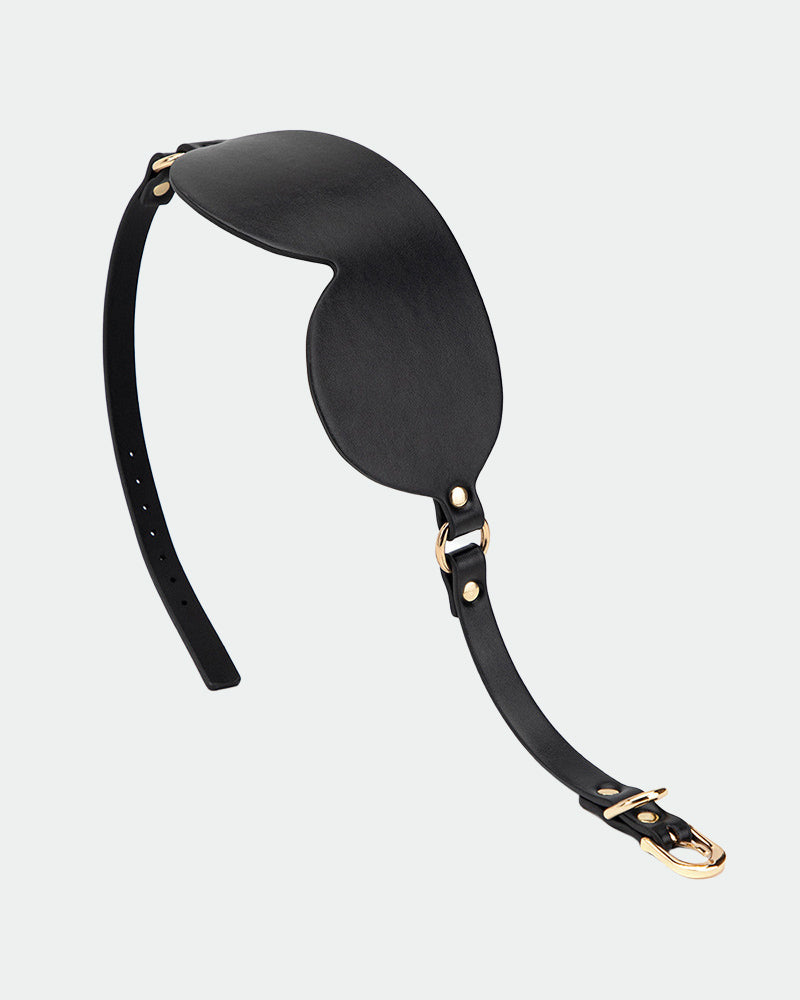 Black leather eye mask with curved eye cup and long strap with buckle hardware