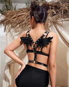 Black leather wing harness with wing shoulders and back straps, worn on model