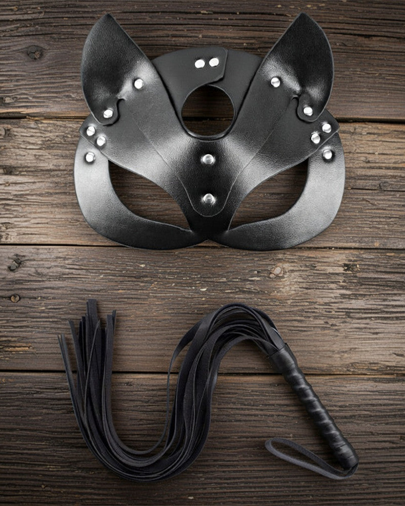 Leather cat mask with ear cutouts, eye opening, and stud details with black tassel leash