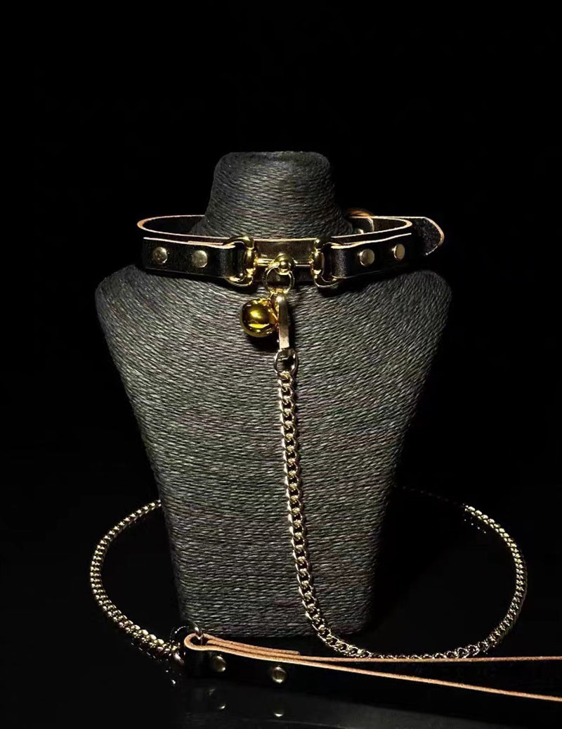 Black choker collar on mannequin with bell pendant and long chain leash