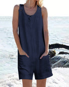 Dark blue sleeveless pocket shorts jumpsuit with button placket and scoop neckline