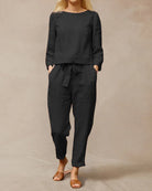 Black two-piece pants set with long-sleeve top and drawstring waist ankle pants
