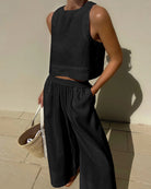 Black sleeveless crop top and wide-leg pants set with elastic waist, relaxed fit.