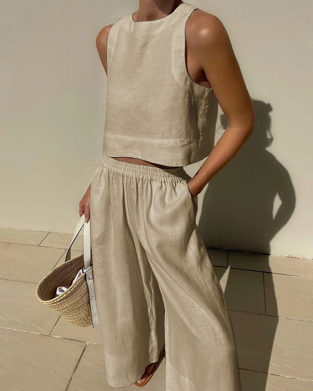 Cream sleeveless crop top and wide-leg pants set with elastic waist, loose wide legs.