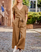 Brown romper jumpsuit with V-neck, short sleeves, waist tie belt, wide-leg pants