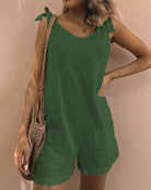 Sleeveless green pocket shorts jumpsuit with bow shoulder ties and side pockets